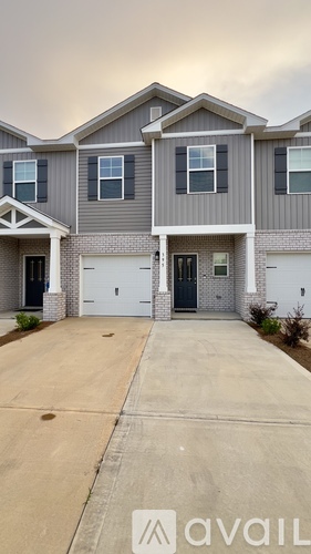 A modern two-story house with a garage is available for sale.