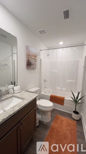 A bathroom with a toilet, sink, and shower.