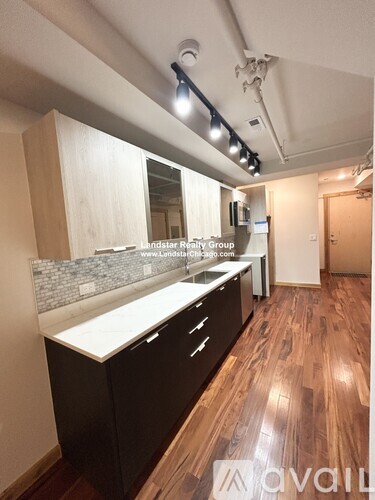 A kitchen with wooden floors and a counter top.