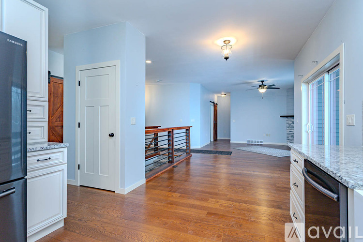 A room with a ceiling fan and two doors.