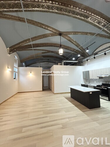 A room with wooden floors and a black bench.