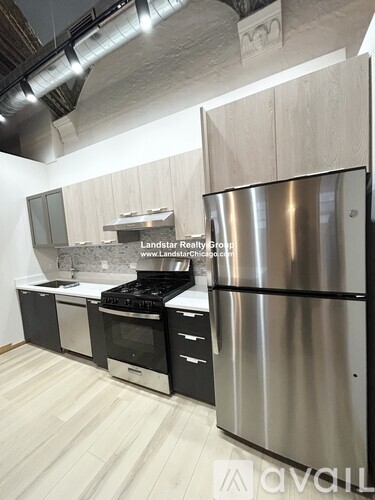 A kitchen with a stainless steel refrigerator and wooden cabinets.
