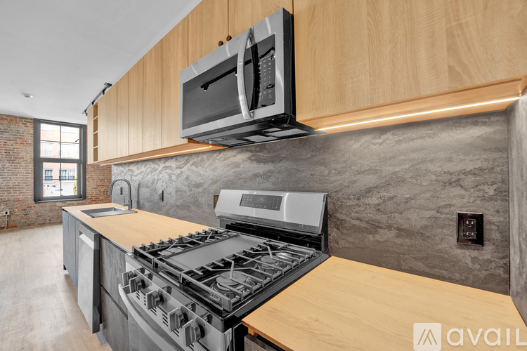 A modern kitchen with a wooden countertop and a stainless steel stove.