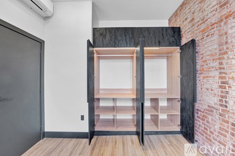 A room with a brick wall and a wooden floor.
