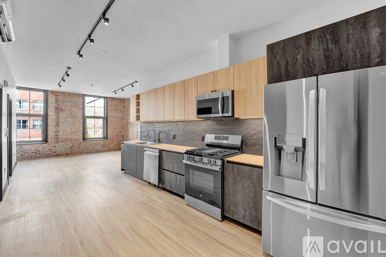 A modern kitchen with stainless steel appliances and wooden accents.
