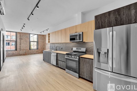 A modern kitchen with stainless steel appliances and wooden accents.