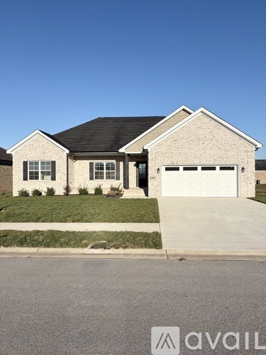 A two-story house with a garage is available for sale.