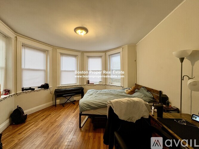 A bedroom with a bed, desk, and chair.