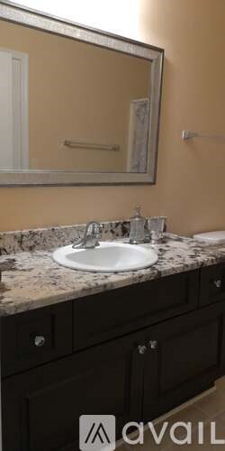 A bathroom with a sink and a mirror.