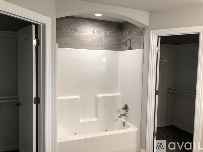 A white bathroom with a bathtub and a shower.