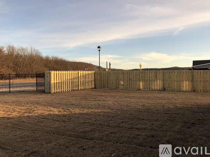 A fenced area with a gate and a lamp post.