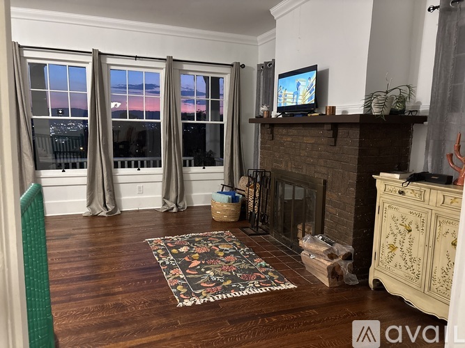 A living room with a fireplace and a television on the mantle.