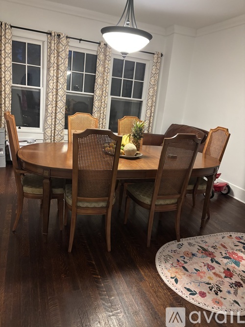 A dining room with a table set for six.