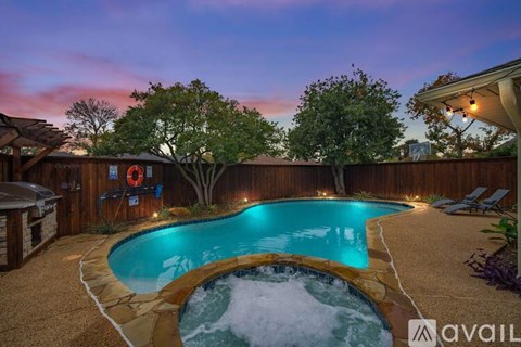A backyard with a pool and deck area.