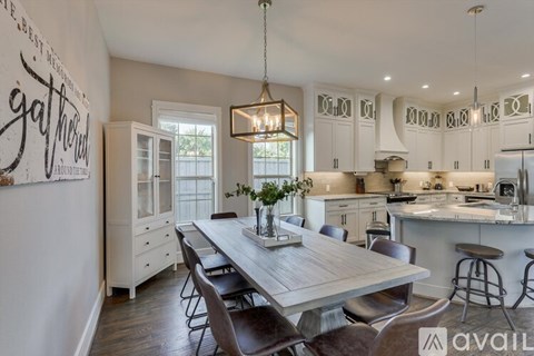 A modern kitchen with a dining table and chairs.
