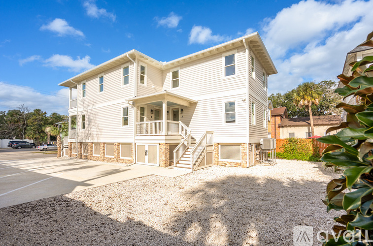 A two-story house with a front porch and a garage.
