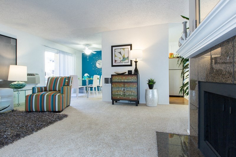 Sienna Apts living room with carpeted area and a sofa chair for sitting