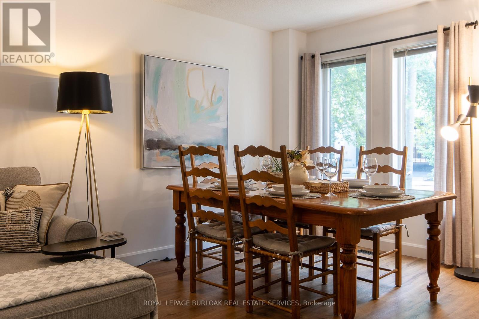 A dining room with a table set for four.
