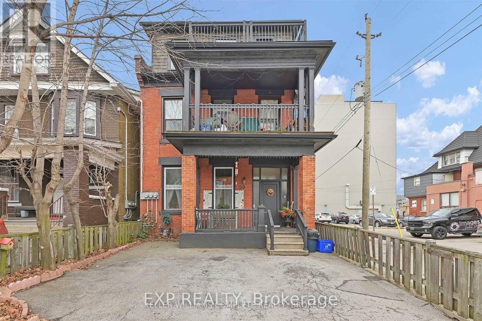 A two-story house with a balcony on the second floor.