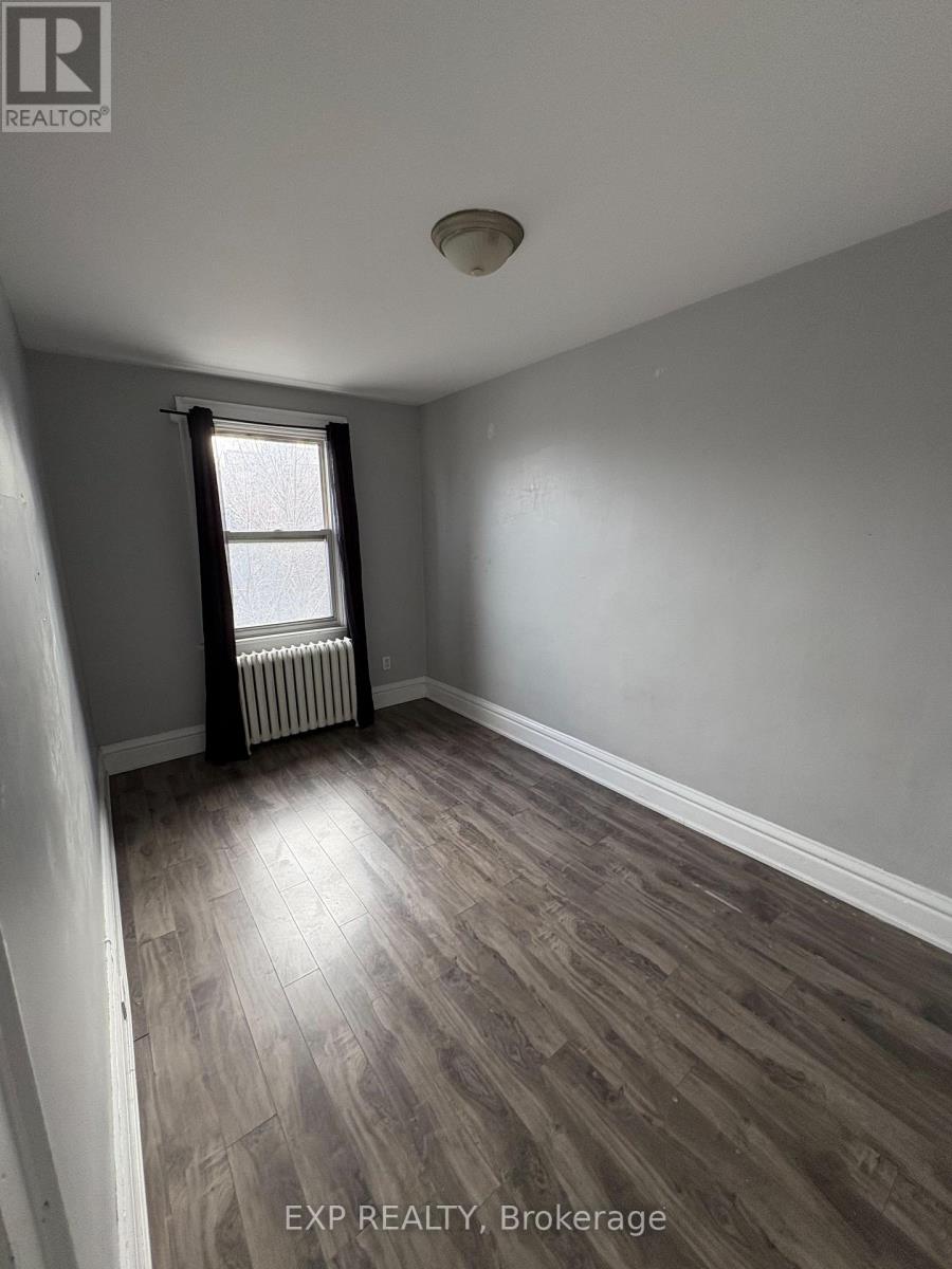 A room with a window and a radiator on the floor.