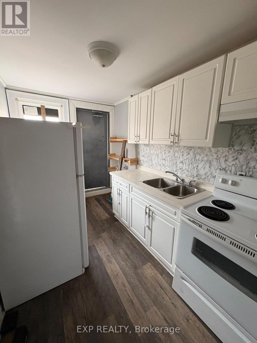 A kitchen with white appliances and cabinets.