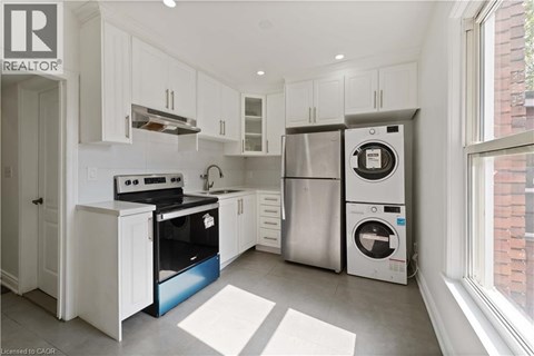 A modern kitchen with white cabinets and stainless steel appliances.