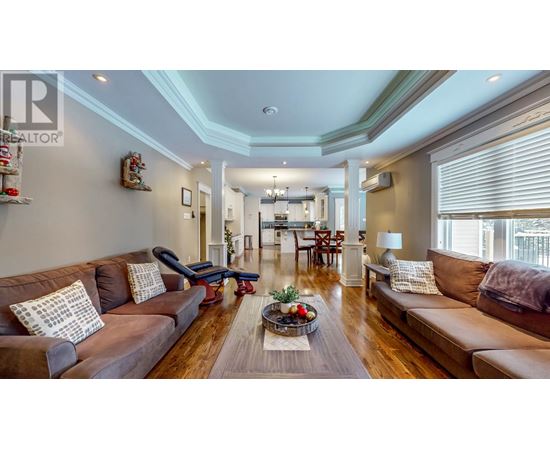 A living room with brown couches and a wooden floor.