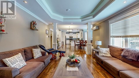 A living room with brown couches and a wooden floor.