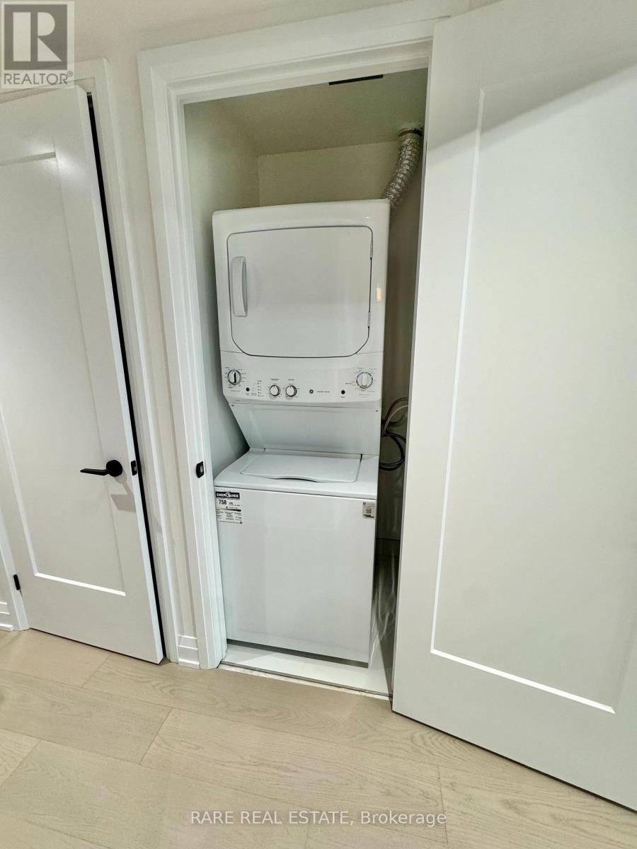 A white washing machine is in a cabinet.