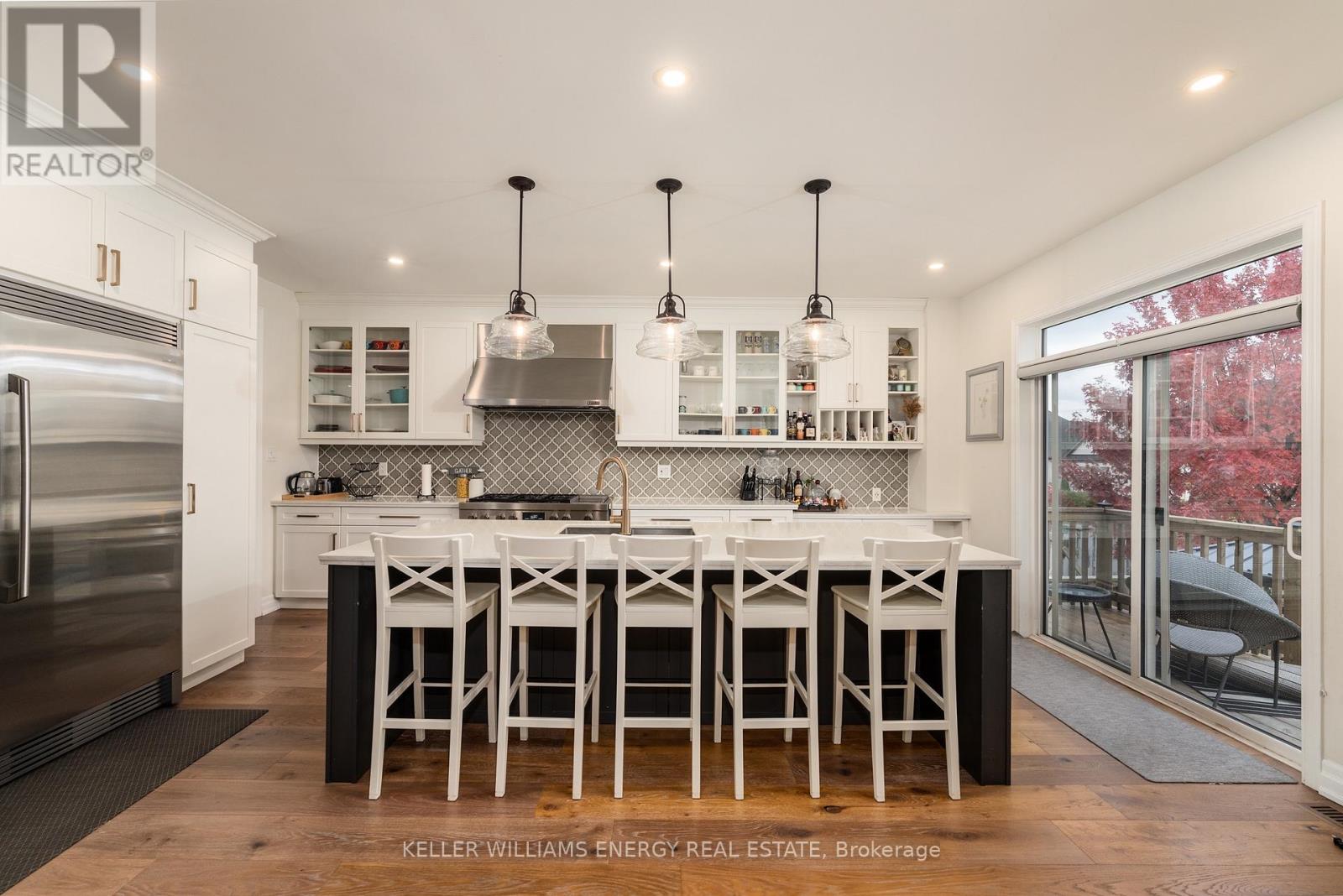 A modern kitchen with white cabinets and a large island.