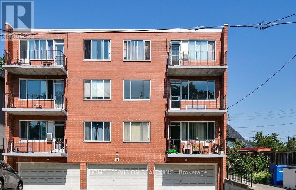 A red brick building with balconies and a sign that reads "HOMELIFE VISION REALTY INC., Brokerage".