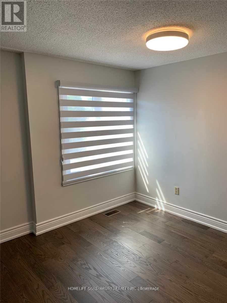 A room with a window covered by horizontal blinds.