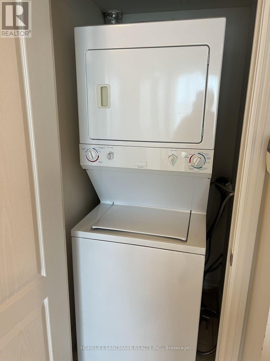 A white dishwasher is in a small kitchen.