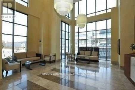 A large, well-lit lobby with a marble floor and a reception desk.