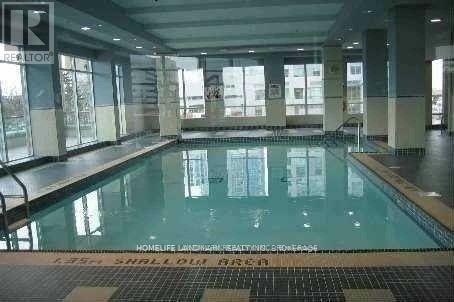 A large indoor swimming pool with a glass bottom.
