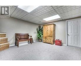 A room with a window and wooden flooring.