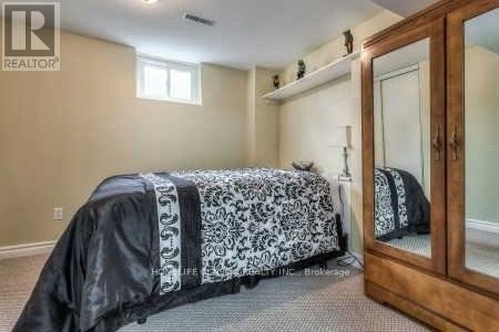 A bathroom with a toilet, sink, and shower stall.