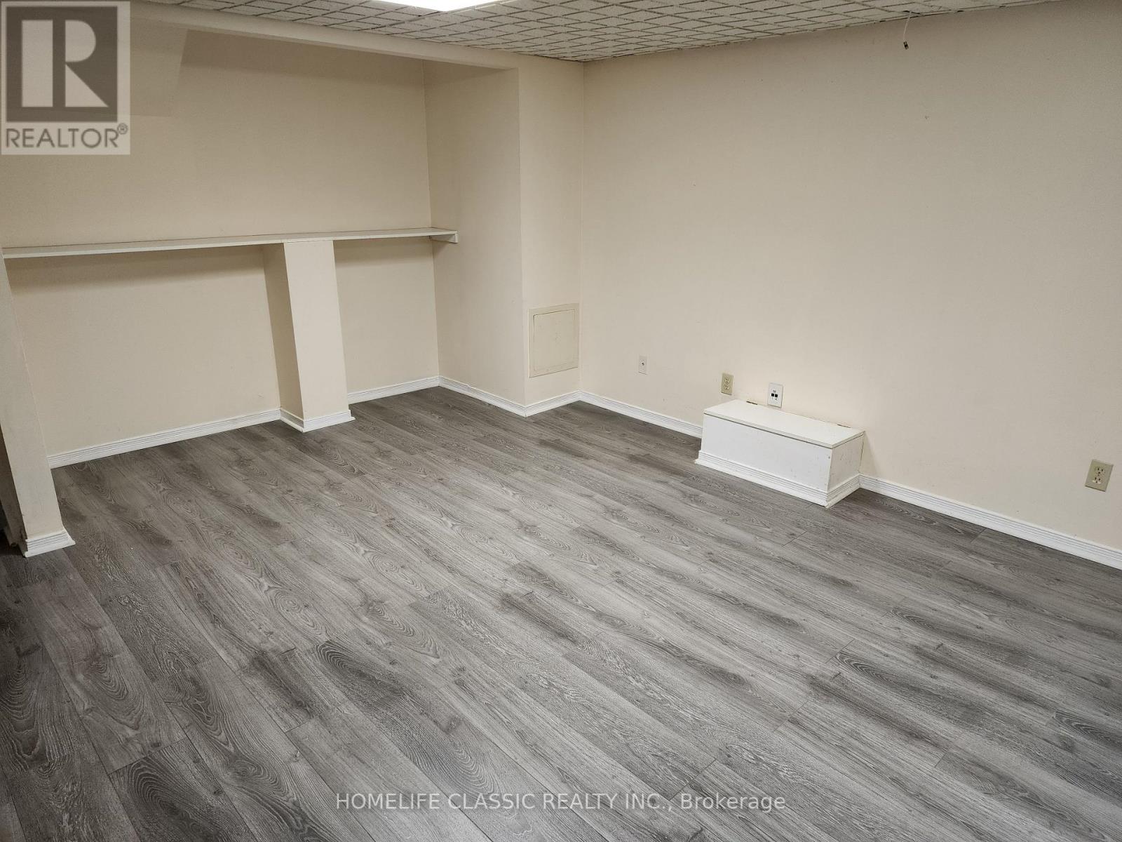 A room with grey flooring and white walls.