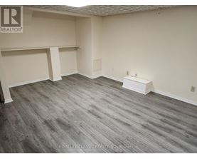 A room with grey flooring and white walls.