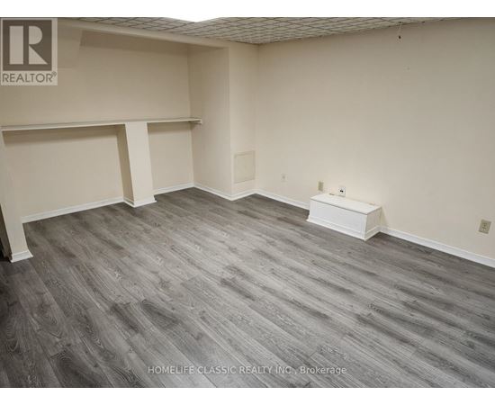 A room with grey flooring and white walls.