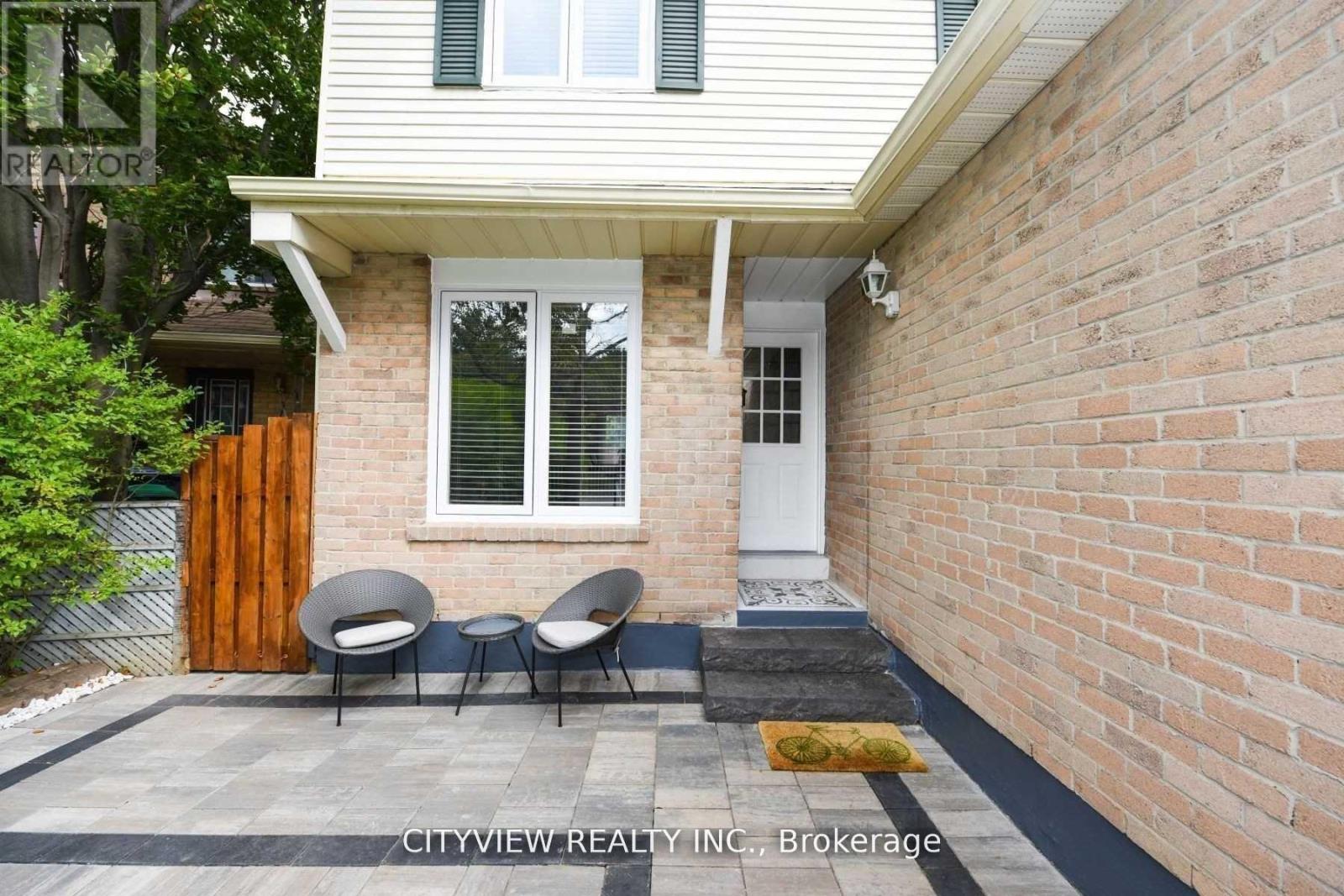 A house with a white door and a brick wall.