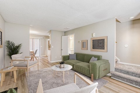 A living room with a green couch and a coffee table.