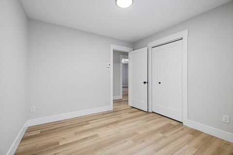 A room with a wooden floor and white walls.