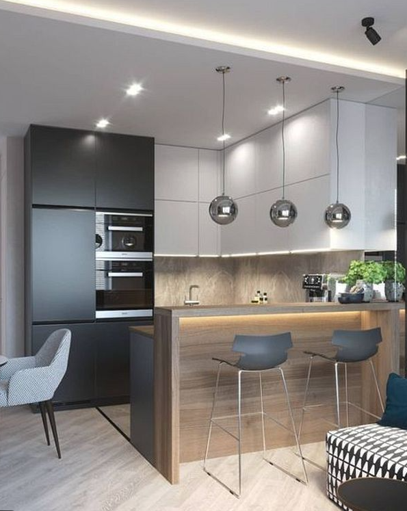 A modern kitchen with a bar area and chairs.