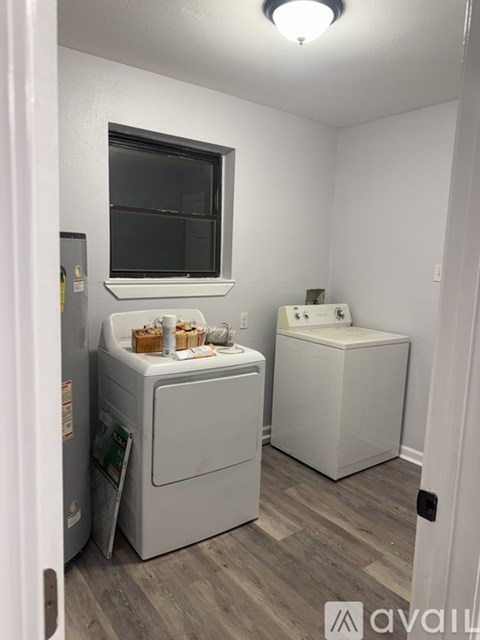 A small laundry room with a washer and dryer.