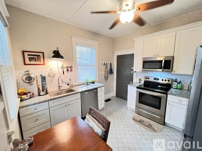 A kitchen with a table and chairs in the middle of it.