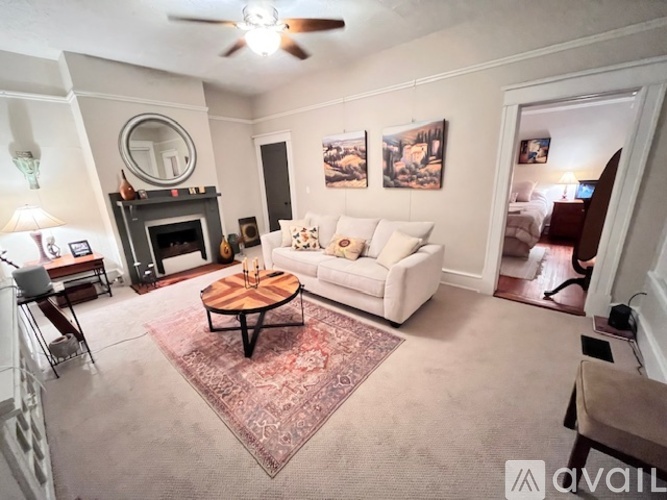 A living room with a fireplace and a couch.