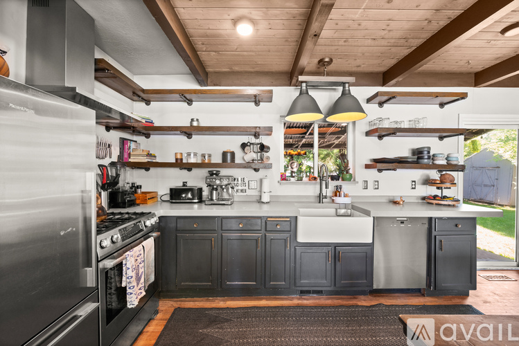 A kitchen with a stove top oven and a sink.