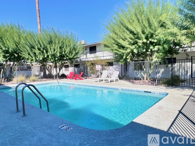 A pool surrounded by trees and a fence with a sign that says "available".