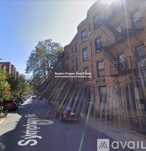 A street view of a residential area with the text "Boston Proper Real Estate" and a website address.